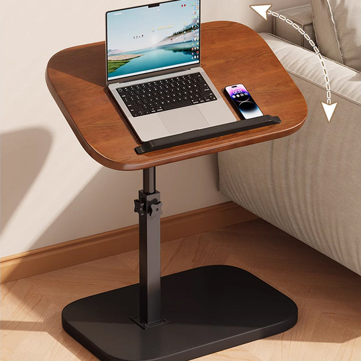 Stolik mobilny pod laptopa ustawiony przy sofie z możliwością regulacji wysokości