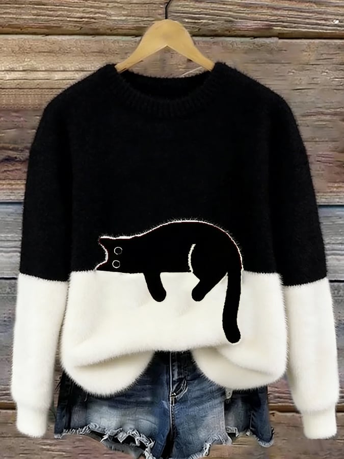 Wzorzysty sweter damski z kotem, zbliżenie na miękki materiał i ściągacze