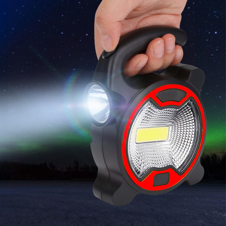 Przenośna lampa robocza COB LED trzymana w dłoni z włączonym światłem