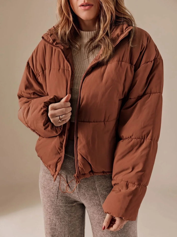 Kobieta w brązowej krótkiej kurtce puchowej oversize