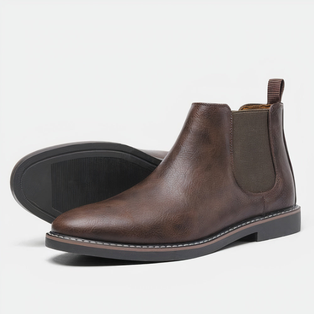Boczny widok męskich brązowych butów chelsea boots na białym tle