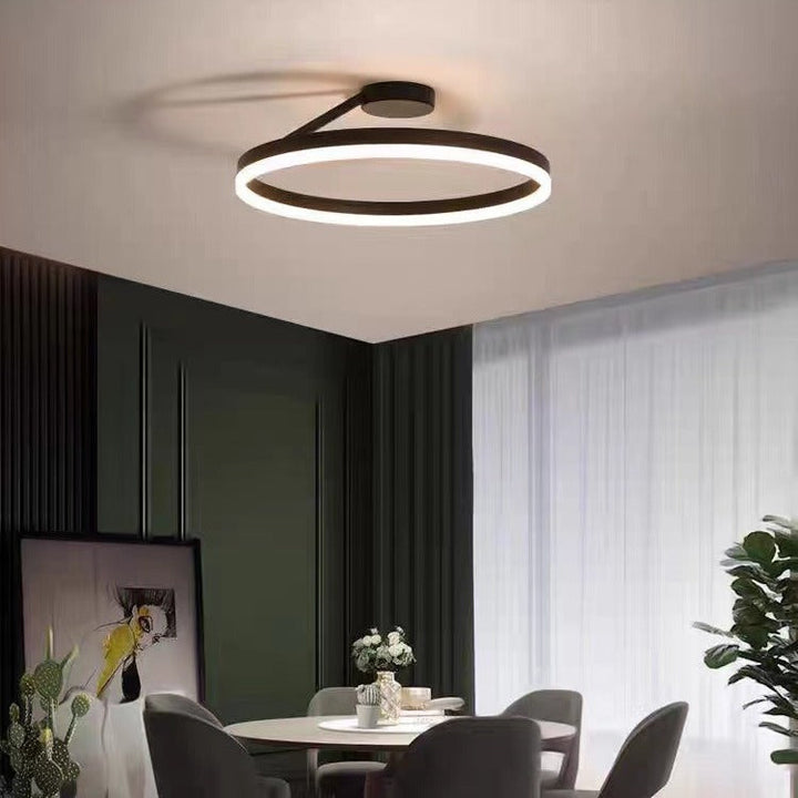 Nowoczesna czarna lampa sufitowa LED Halo zamontowana w eleganckiej jadalni