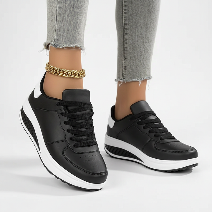 Widok z bliska na czarne sneakersy ortopedyczne na jasnym tle