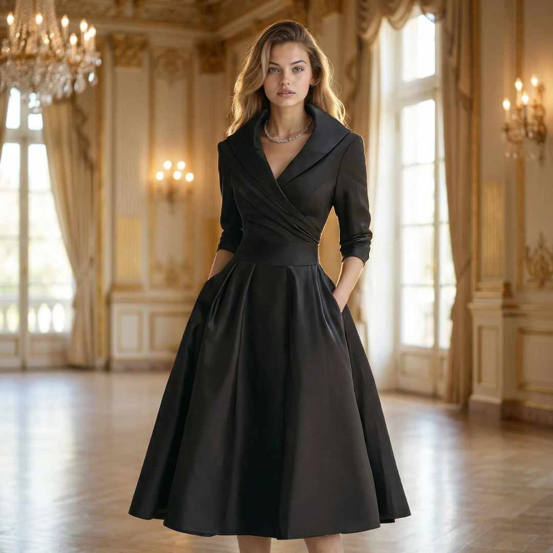 Kobieta w eleganckiej czarnej sukience midi Emilie prezentująca fason z rozkloszowanym dołem