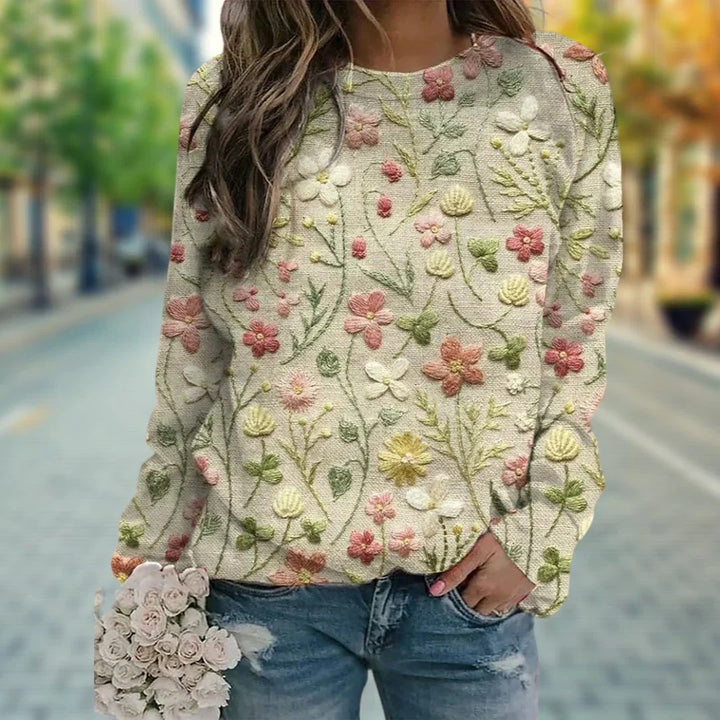 Beżowy sweter damski z haftowanymi kwiatami, luźny krój, okrągły dekolt. Idealny na jesień i zimę. Elegancki i modny.