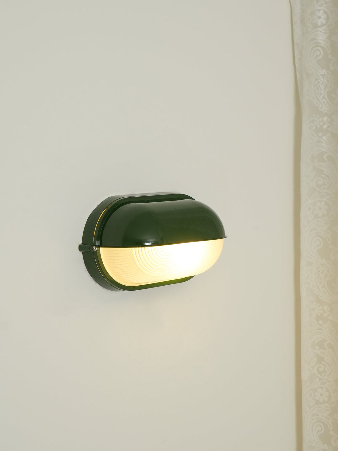 Czarna owalna lampa zewnętrzna, stylowa, odporna na warunki atmosferyczne.