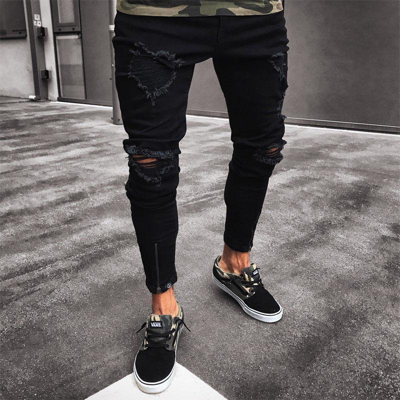 Czarne męskie jeansy slim fit z modnymi przetarciami, idealne do casualowych stylizacji streetwear.