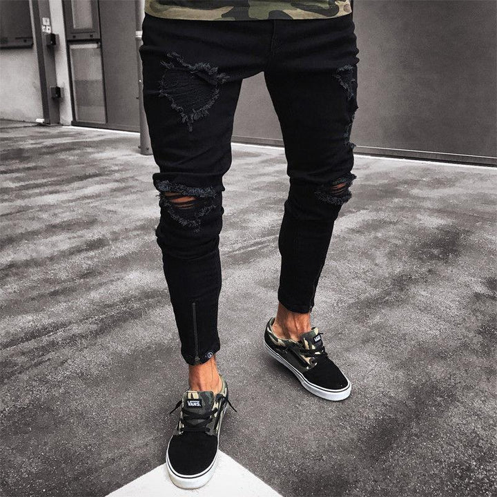Czarne męskie jeansy slim fit z modnymi przetarciami, idealne do casualowych stylizacji streetwear.