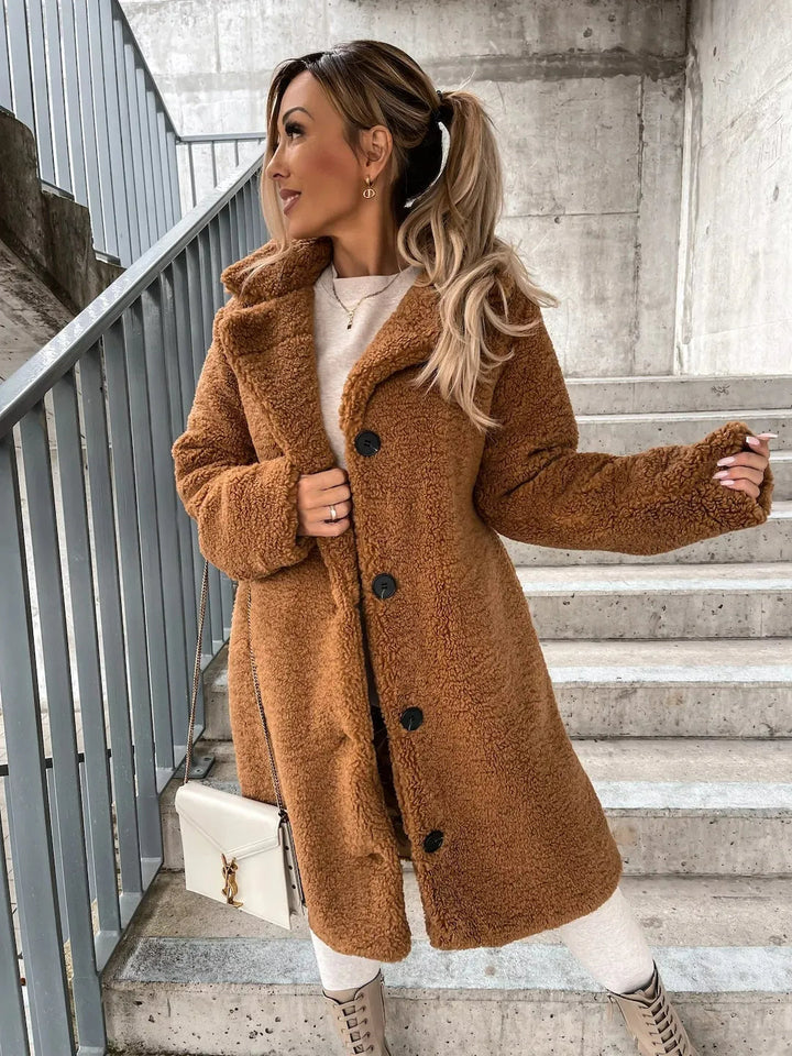 Miękki płaszcz teddy damski oversize. Długi, beżowy, z guzikami, modne okrycie wierzchnie na chłodne dni.