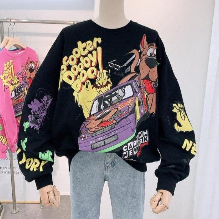 Modna damska bluza z dzianiny oversize z zabawnym nadrukiem kreskówkowym. Nierozpinana, komfortowa.