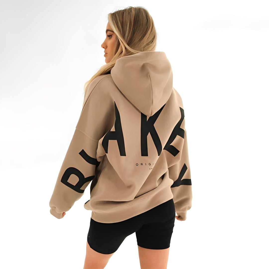 Bluza damska z kapturem w stylu oversize, z modnym nadrukiem. Idealna do casualowych stylizacji.