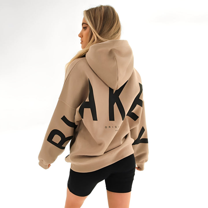 Bluza damska z kapturem w stylu oversize, z modnym nadrukiem. Idealna do casualowych stylizacji.
