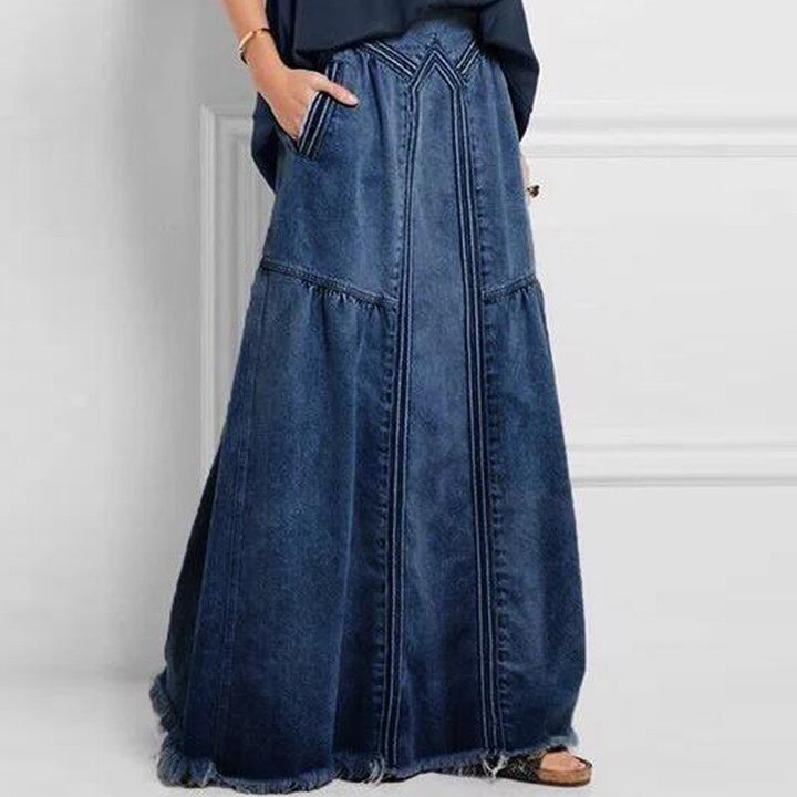 Modna spódnica maxi damska z gumką w pasie, rozkloszowana, z kieszeniami, na styl casual i elegancki.