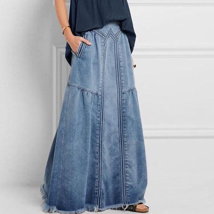 Elegancka spódnica maxi damska, rozkloszowana, z praktycznymi kieszeniami i subtelnymi przeszyciami.