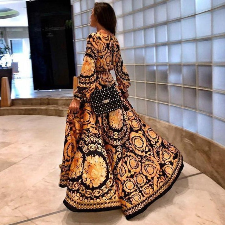Lekka sukienka damska maxi kopertowa w stylu boho, z długim rękawem, podkreślająca talię.