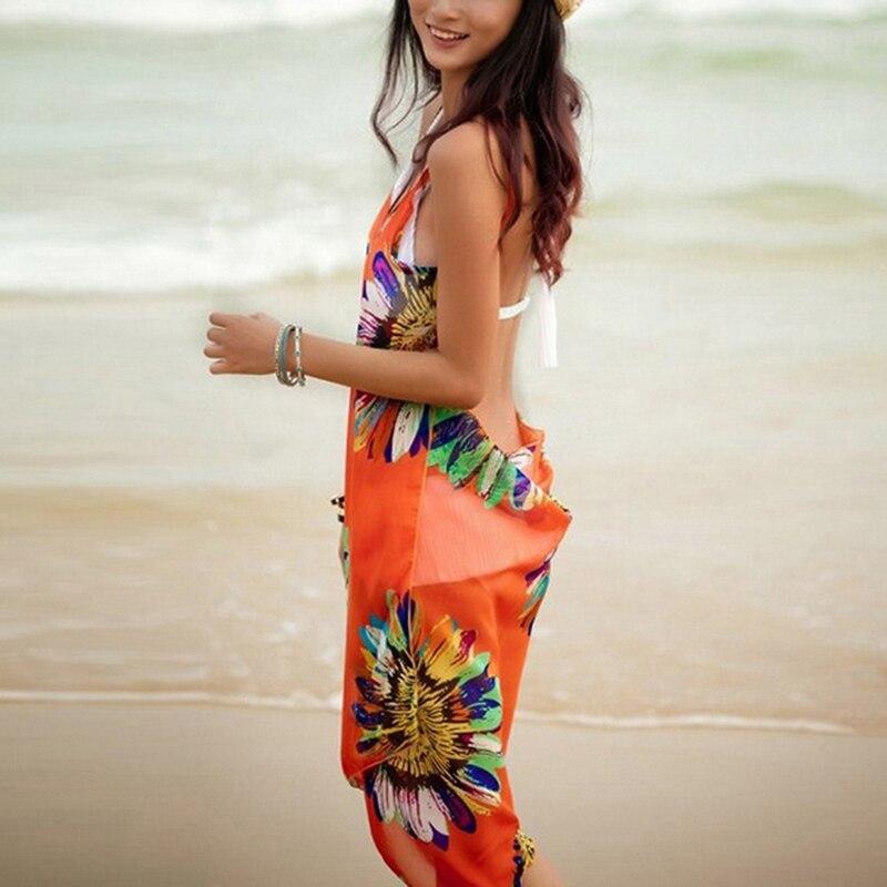 Krótka sukienka plażowa damska, z wiązaniem i eleganckim kwiatowym wzorem. Na modne wakacje.