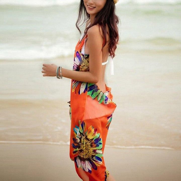 Krótka sukienka plażowa damska, z wiązaniem i eleganckim kwiatowym wzorem. Na modne wakacje.