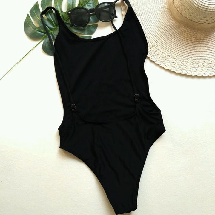 Modny neonowy monokini kąpielowy, jednoczęściowy, z odważnie odkrytymi plecami, na plażę.