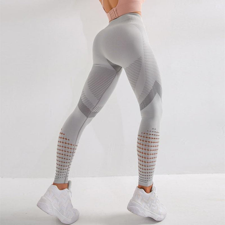 Damskie legginsy sportowe z wysokim stanem i modnymi wycięciami. Idealne do fitnessu i treningu.