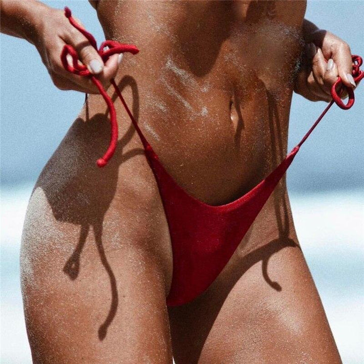Damskie stringi od bikini z regulowanym wiązaniem po bokach, idealne na plażę. Modne kąpielówki na lato.