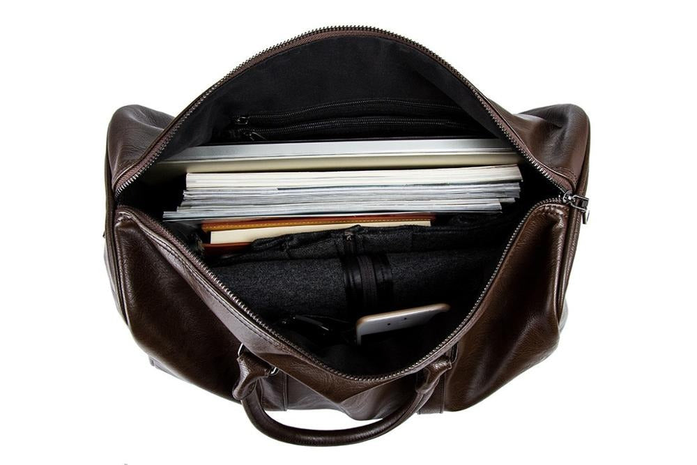 Elegancka skórzana torba duffel unisex, pojemna i stylowa, idealna na podróże jako bagaż podręczny.