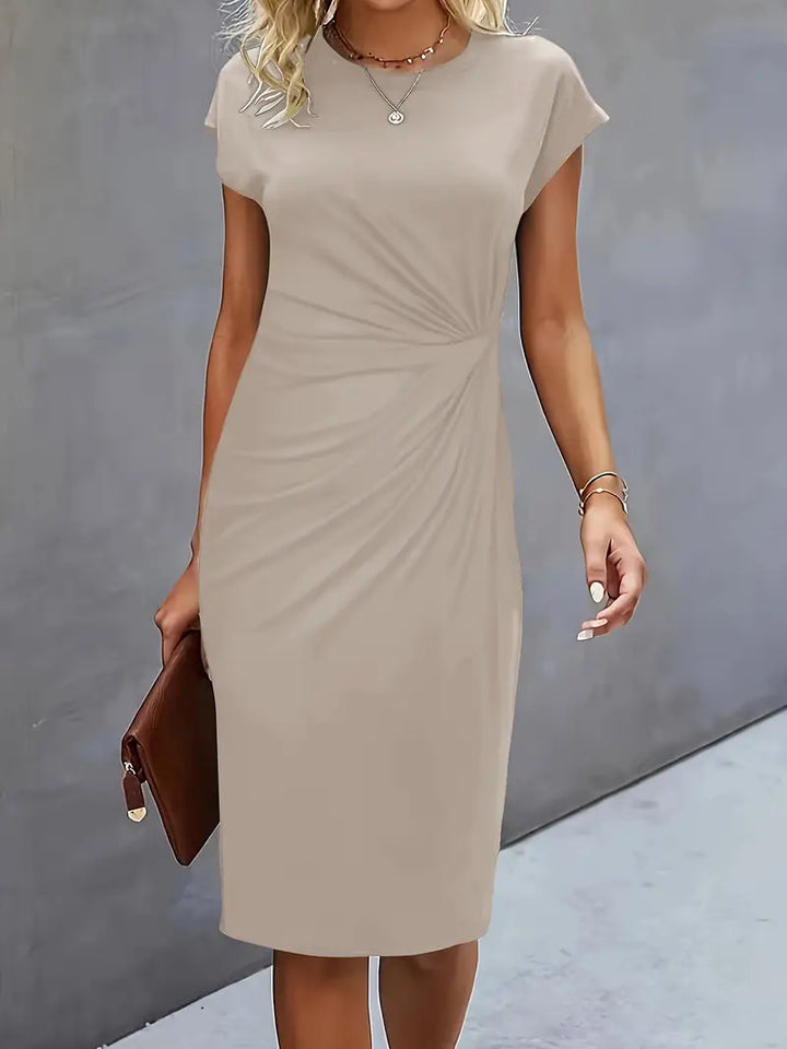 Kobieta w eleganckiej sukience midi z falbanami. Stylizacja na imprezę lub na co dzień.