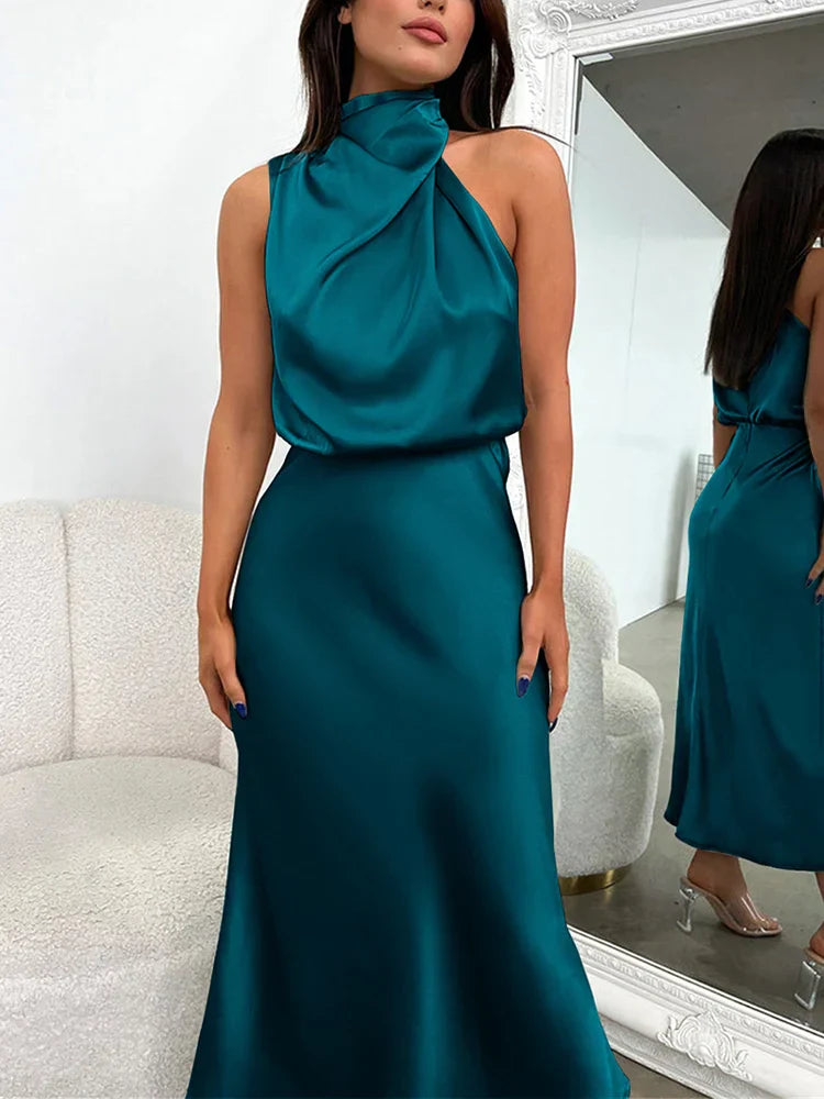 Elegancka sukienka midi z asymetrycznym dekoltem halter. Idealna na letnie uroczystości.