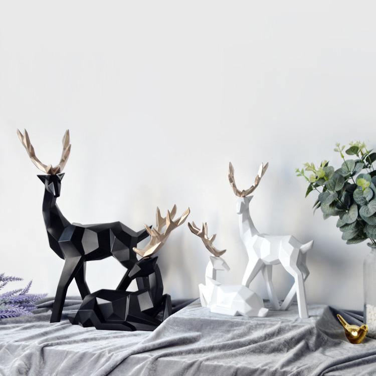 Minimalistyczne figurki reniferów z żywicy, nowoczesna dekoracja wnętrz w stylu skandynawskim.