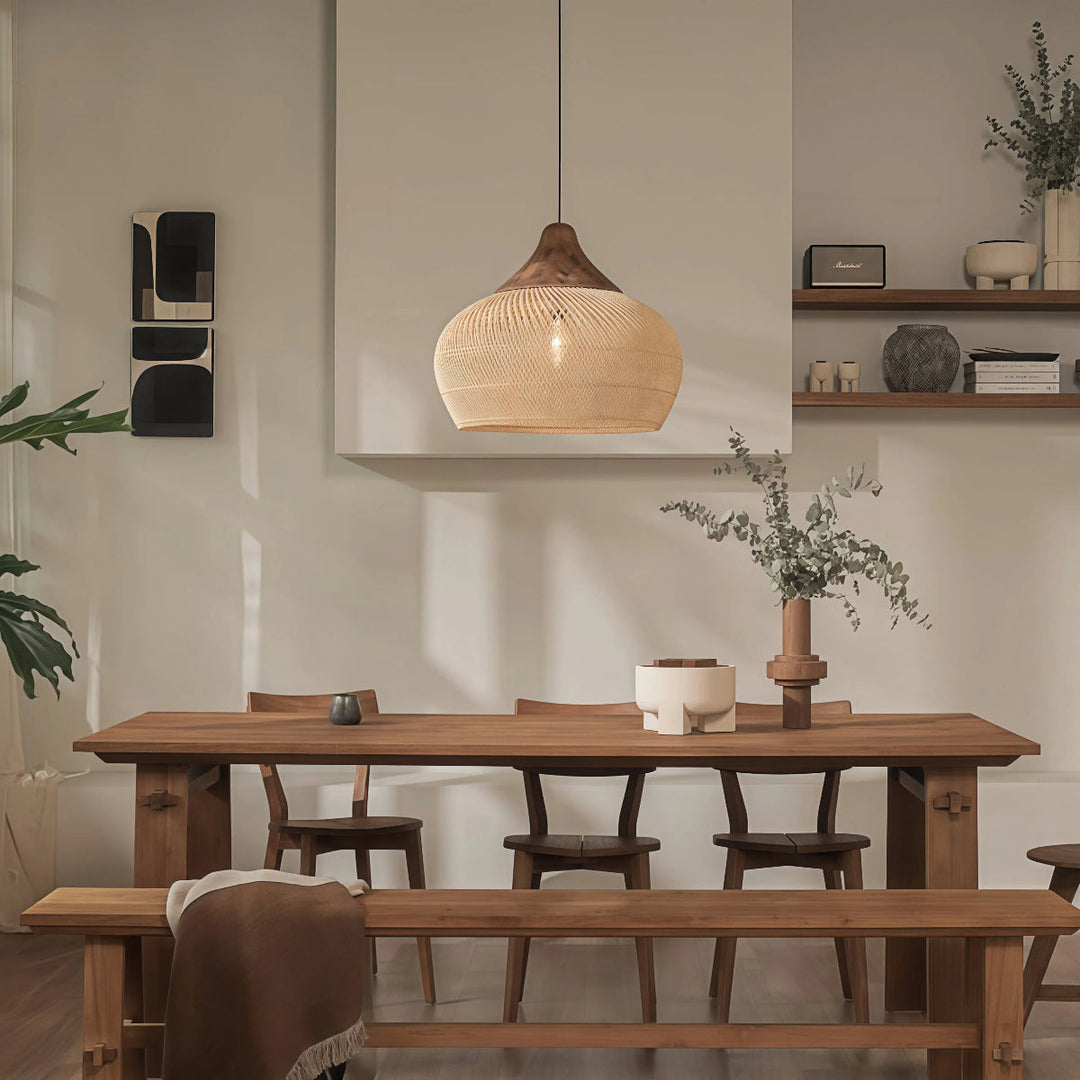 Rattanowa lampa wisząca nad drewnianym stołem w jadalni