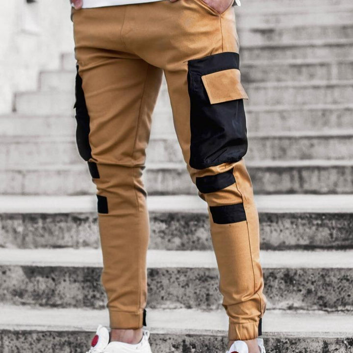 Stylowe męskie bojówki dwukolorowe ze ściągaczami. Modne spodnie cargo slim fit z elastycznymi mankietami.