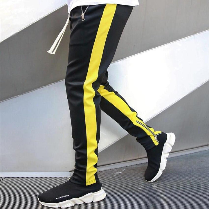 Nowoczesne dwukolorowe spodnie dresowe męskie. Komfortowy krój, sportowy design, modne zamki i rozporki.