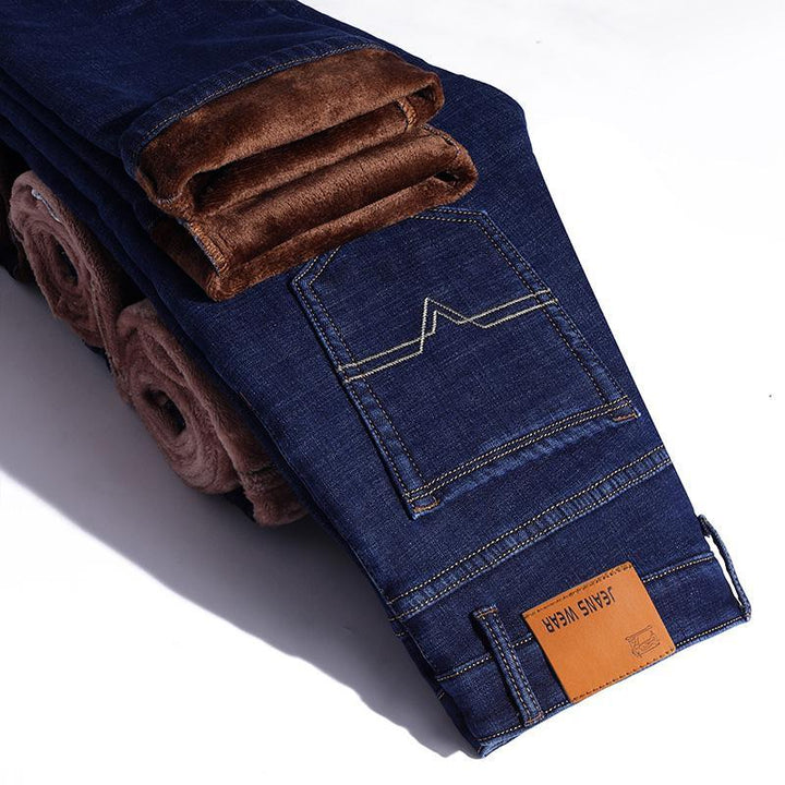 Ciepłe męskie jeansy zimowe typu slim fit, zapewniające komfort. Casualowe, granatowe spodnie z ociepleniem.