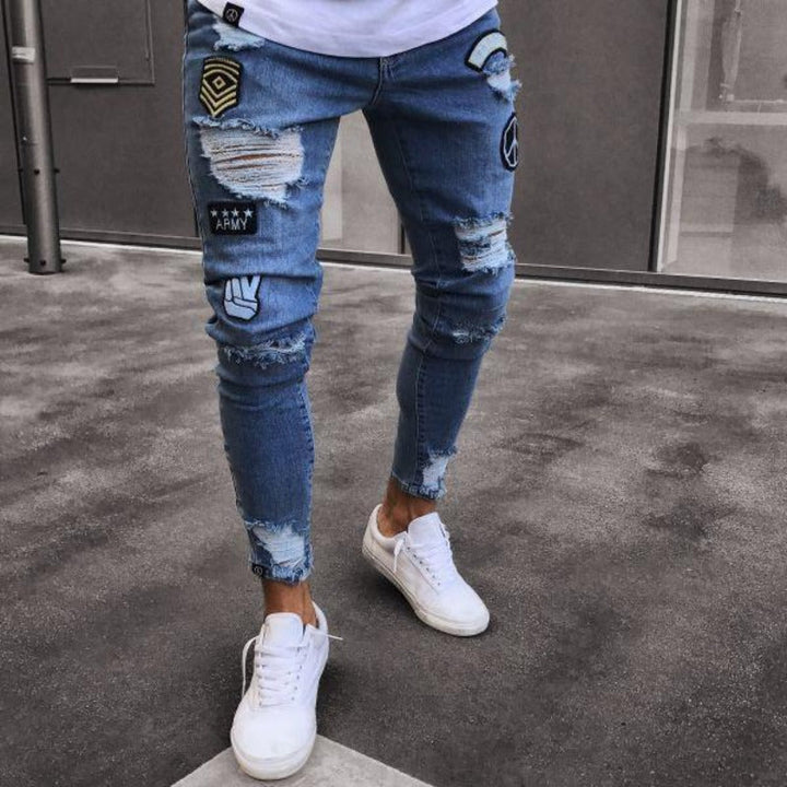 Męskie jeansy slim fit z modnymi dziurami, artystycznymi nadrukami i efektem sprania. Idealne do streetwearu.