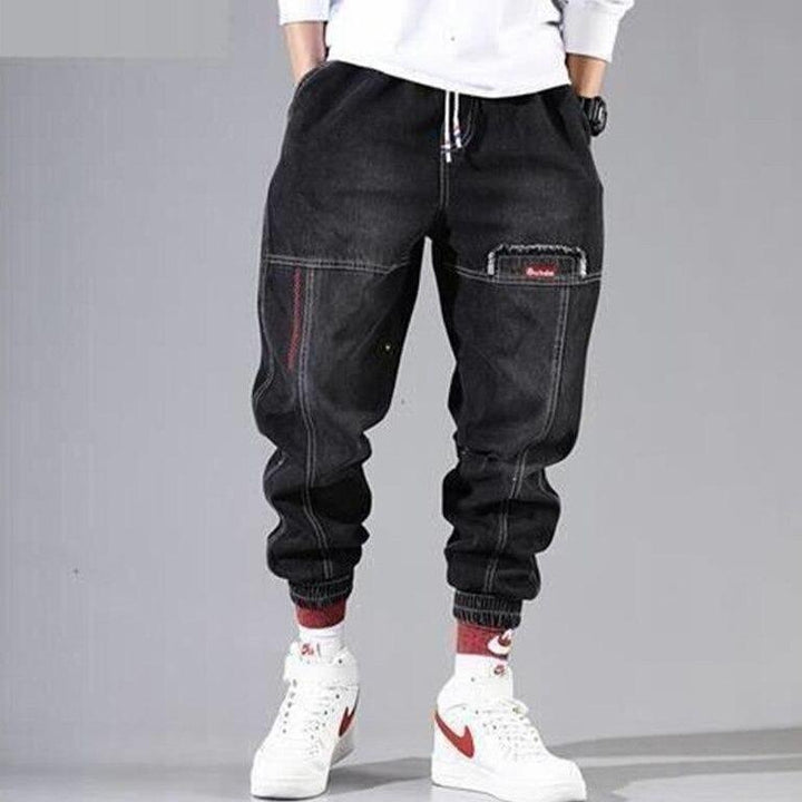 Czarne męskie bojówki cargo, modne i komfortowe, z praktycznymi kieszeniami i elastycznymi ściągaczami. Styl streetwear.