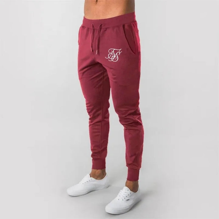 Męskie spodnie dresowe z nadrukiem. Komfortowe, modne, idealne do streetwearu i na co dzień. Wygodna odzież męska.
