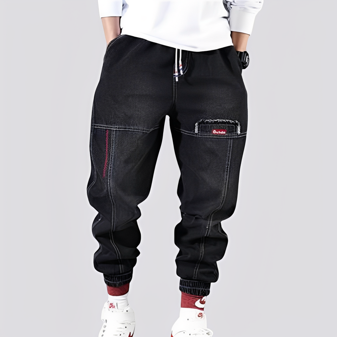 Męskie spodnie baggy jeansy z elastycznymi mankietami. Wygodny, luźny krój dla nowoczesnego stylu streetwear.