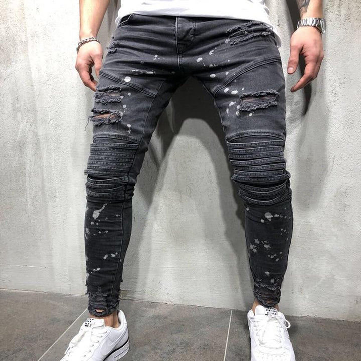 Męskie szare jeansy slim fit z modnymi przetarciami, idealne do casualowych stylizacji i mody ulicznej.