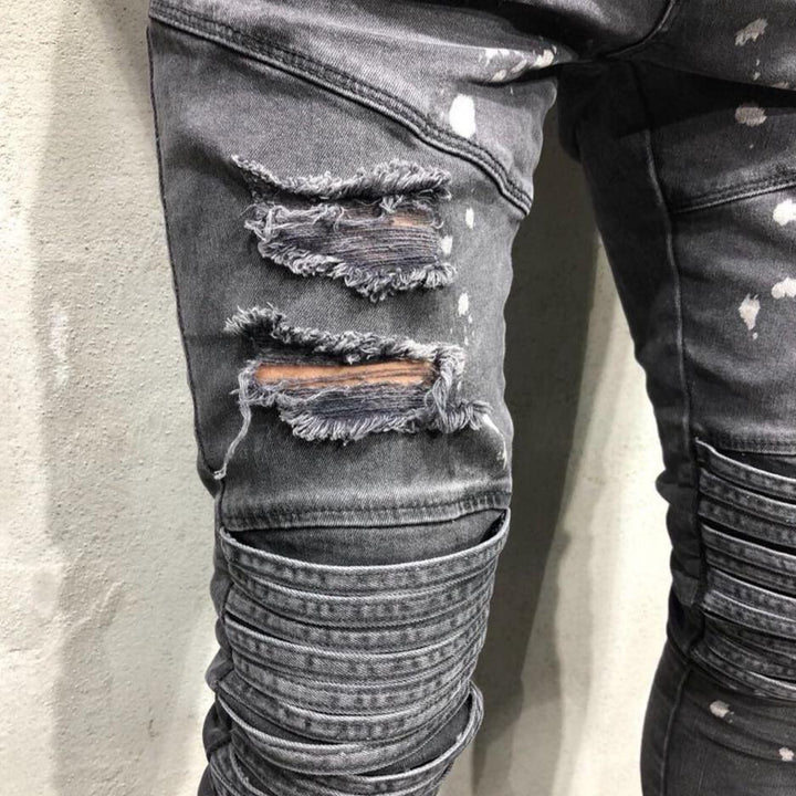 Szare męskie spodnie jeansowe slim fit z przetarciami. Casualowe jeansy męskie do codziennych stylizacji.