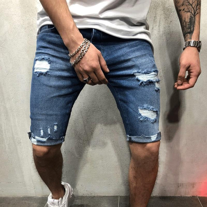 Męskie szorty jeansowe slim fit z modnymi przetarciami, idealne na lato. Stylowe i casualowe szorty denim.