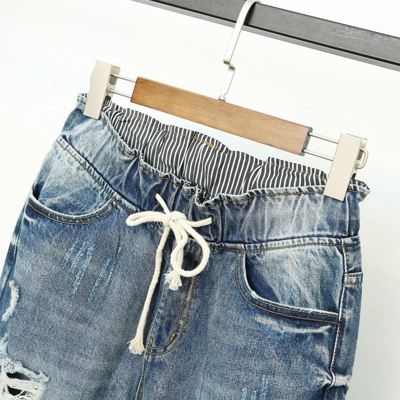 Eleganckie niebieskie jeansy damskie joggery z wysokim stanem, modne i idealne do casualowych stylizacji.