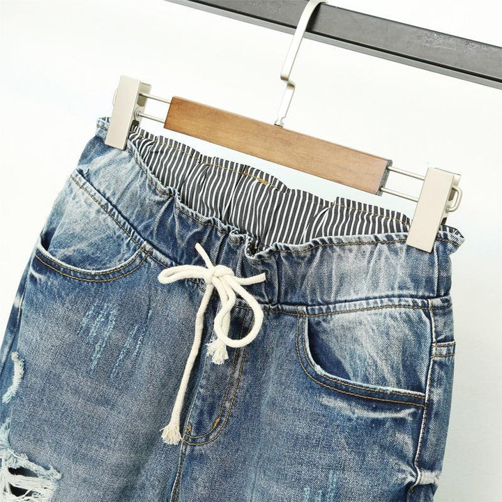Eleganckie niebieskie jeansy damskie joggery z wysokim stanem, modne i idealne do casualowych stylizacji.