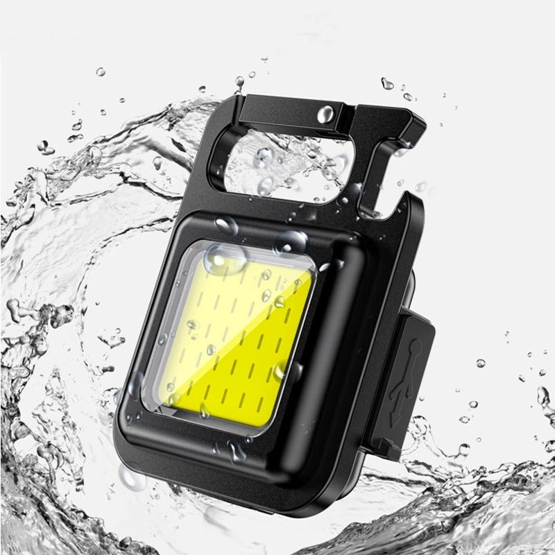 Przenośna latarka LED z powerbankiem, mocnym magnesem, idealna na camping i survival.