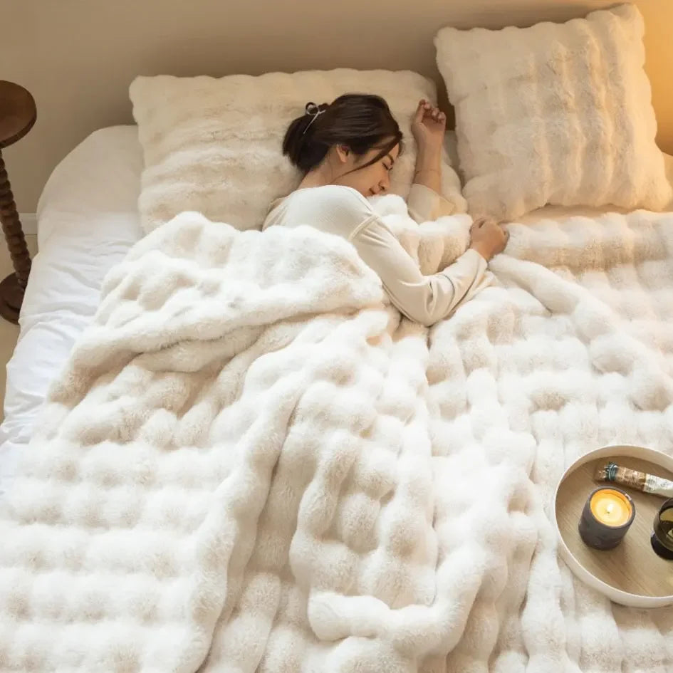 Zbliżenie na puszystą, miękką teksturę wełnianego koca WarmWool, idealnego do otulenia się w domu.
