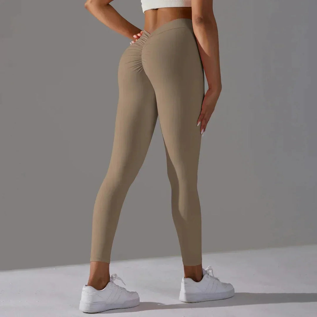 Damskie legginsy treningowe scrunch z wysokim stanem w dynamicznej pozie