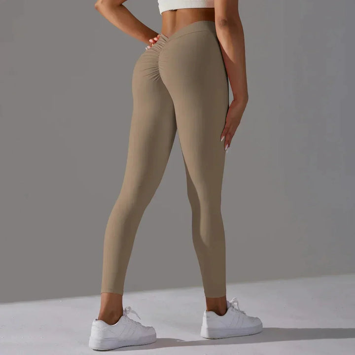 Damskie legginsy treningowe scrunch z wysokim stanem w dynamicznej pozie